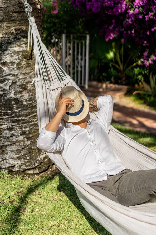 Male relaxing hammock garden (1)